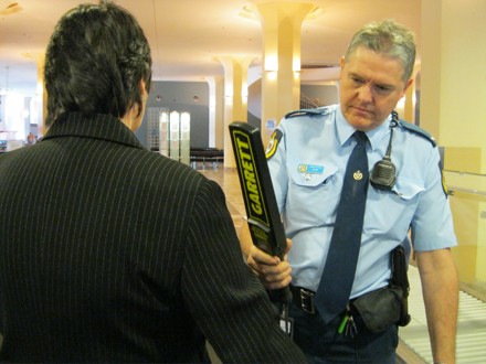 court-securityimg_0267 Sherrif uses a metal detector to scan a man entering the court